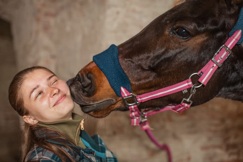a young girl kisses a horse a horse kisses his mi 2021 10 27 07 42 05 utc
